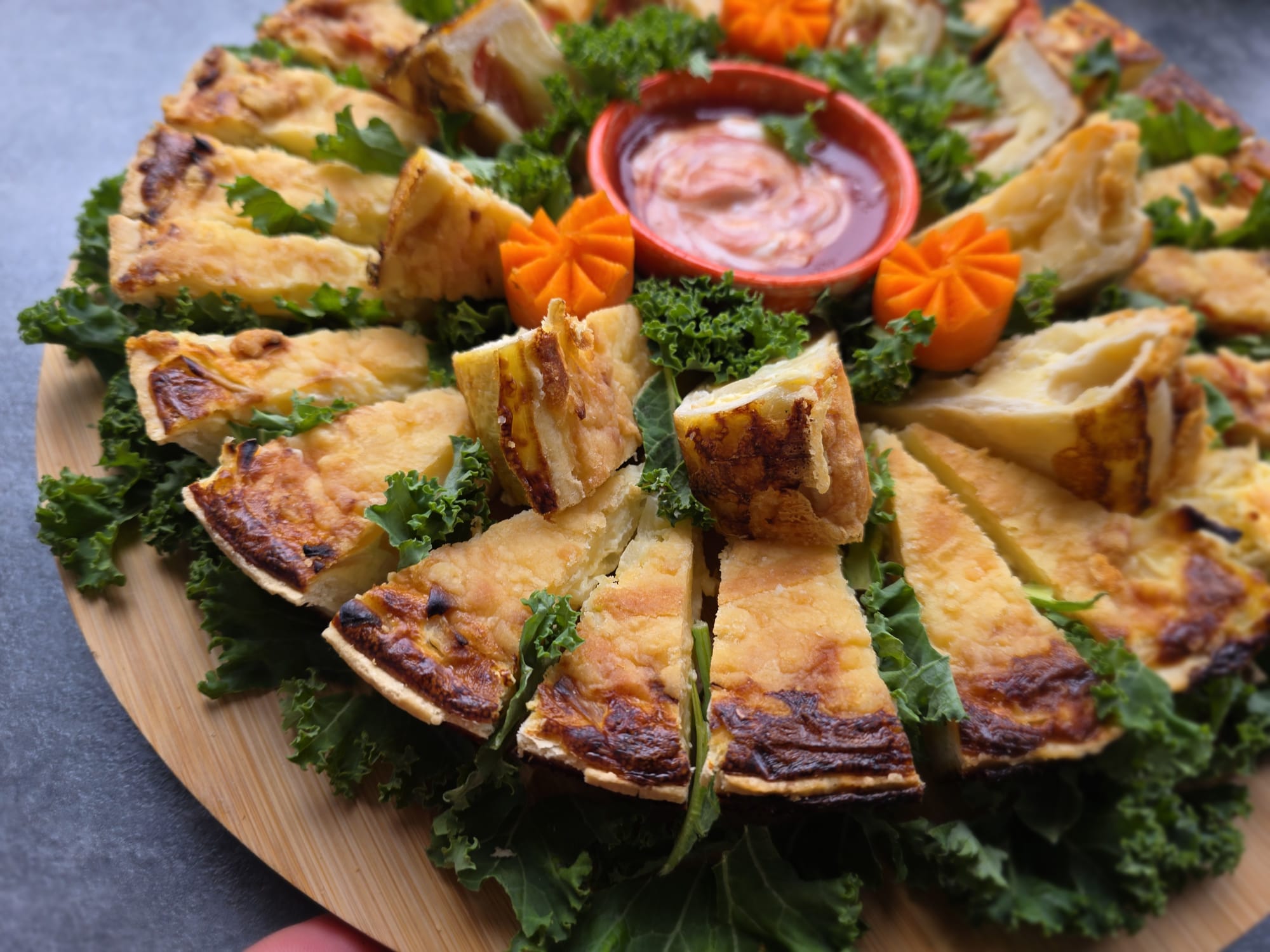Pizza platter on kale with dip